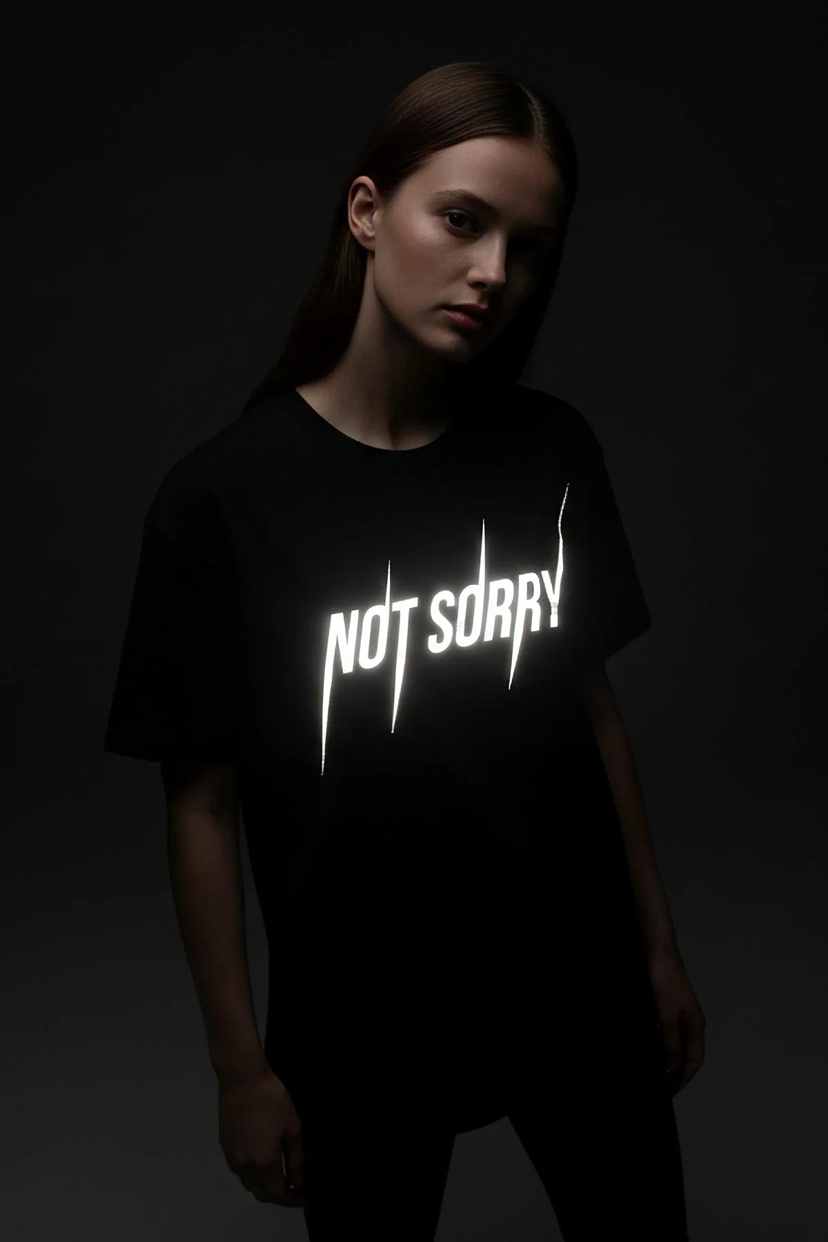 oversized black statement tee reflective chest graphic flash photography detail