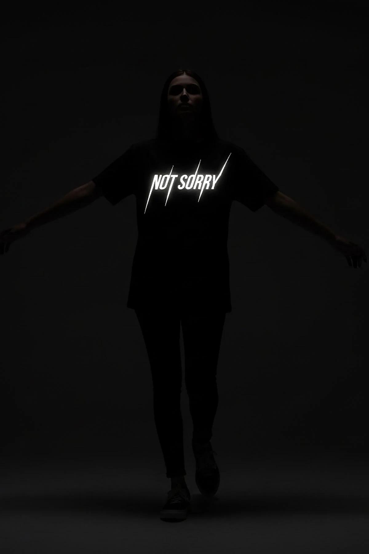 black oversized tee with bold reflective lettering full body side silhouette view