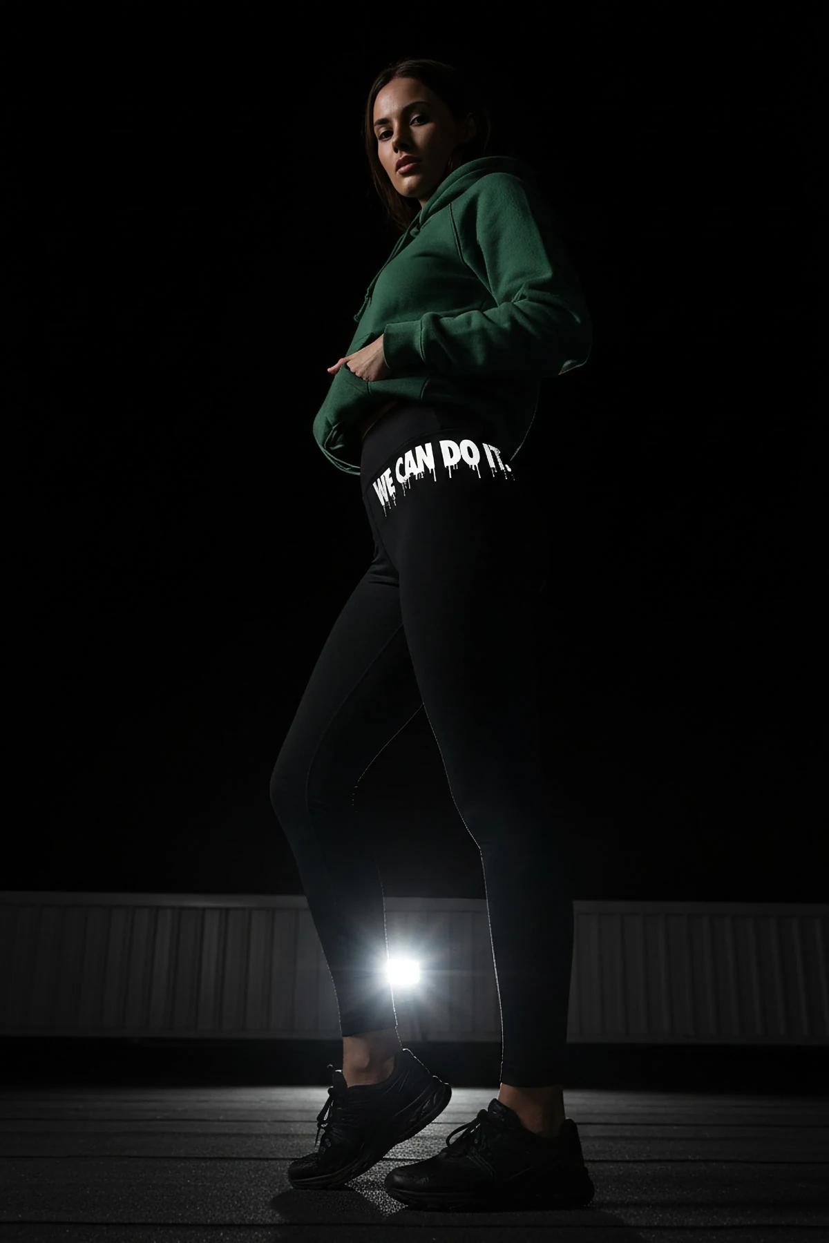 black reflective leggings paired with black sports bra for night running outfit flat-lay