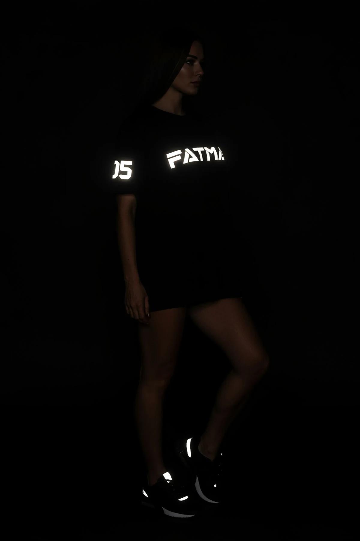 detail shot of reflective transfer print on black ring-spun cotton t-shirt in low light