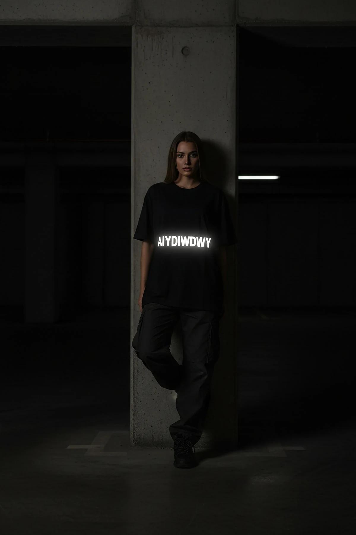 black oversized cotton t-shirt with white reflective custom block-letter chest print, drop-shoulder street fit