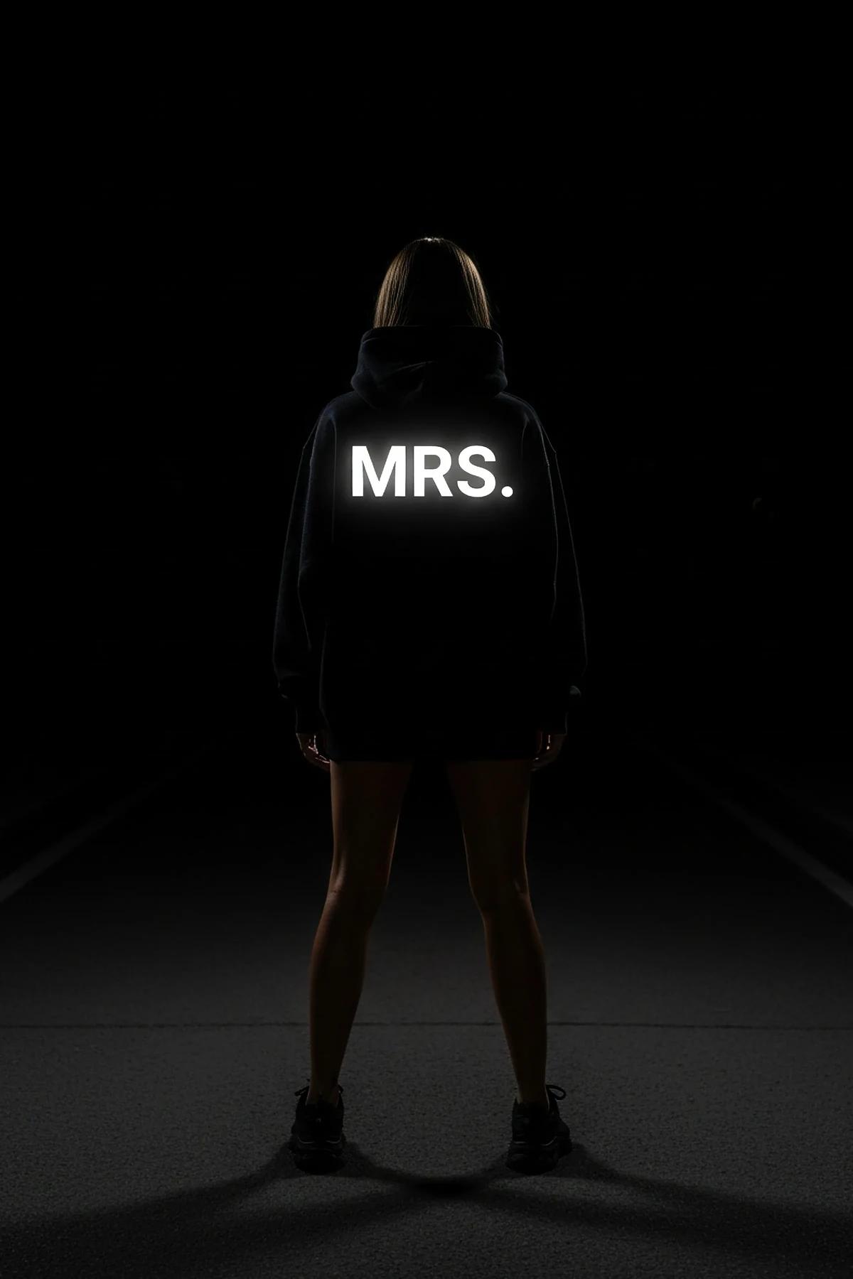 full-length front view of black drop-shoulder hoodie with ribbed cuffs and glow-in-the-dark sleeve detail