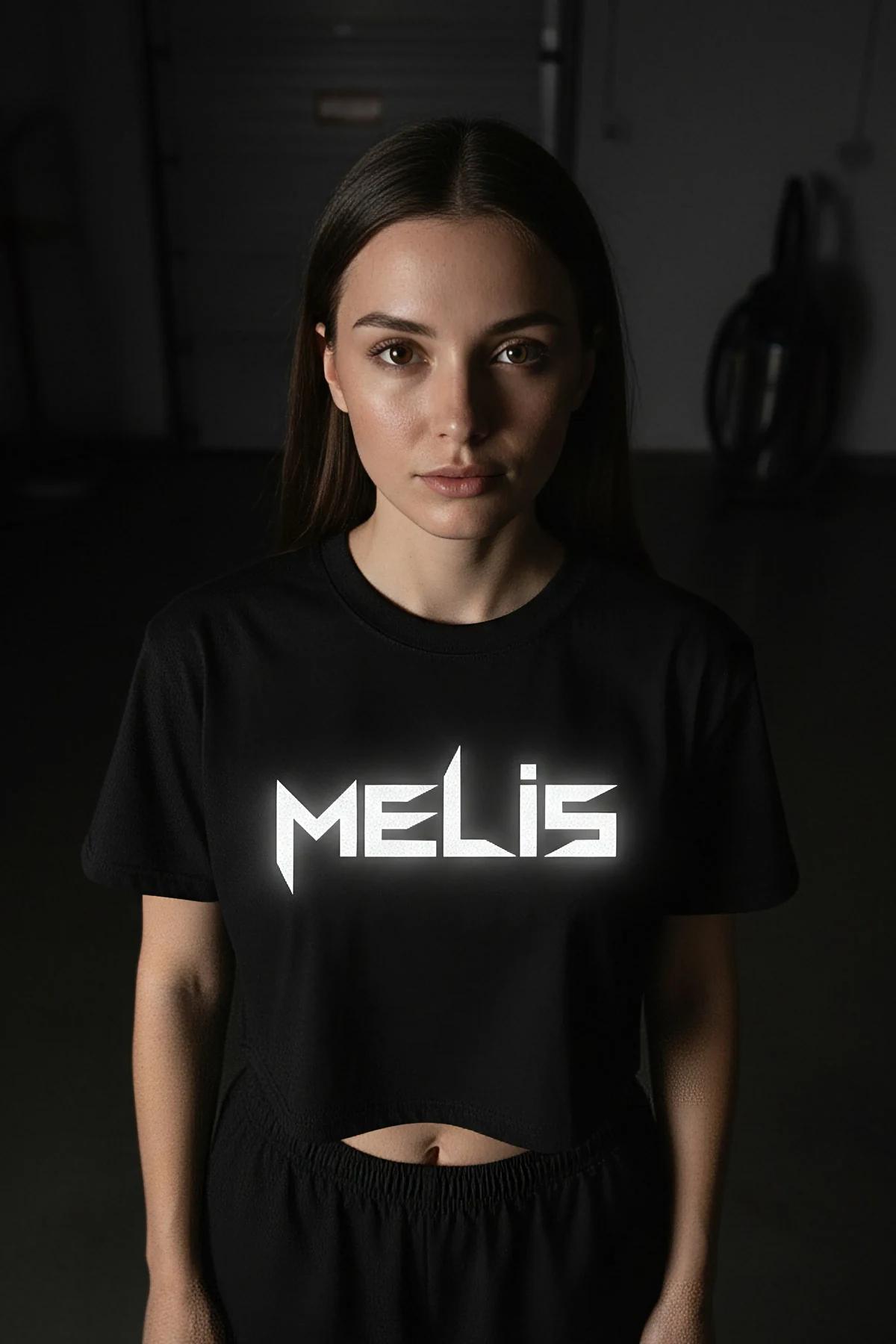 Black cropped T-shirt with reflective logo print worn with black leggings, not a harness product