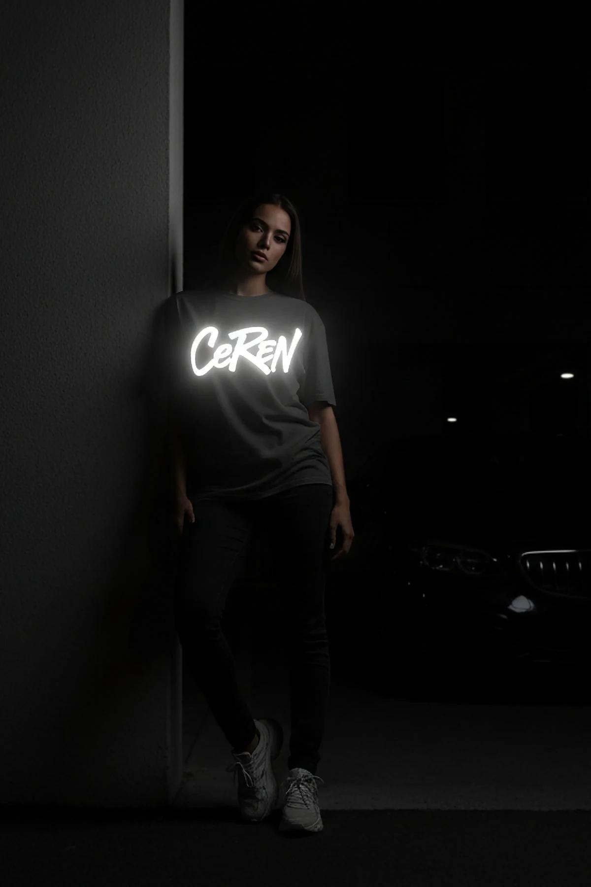 reflective oversized tee grey with bold white glowing custom text print worn at night