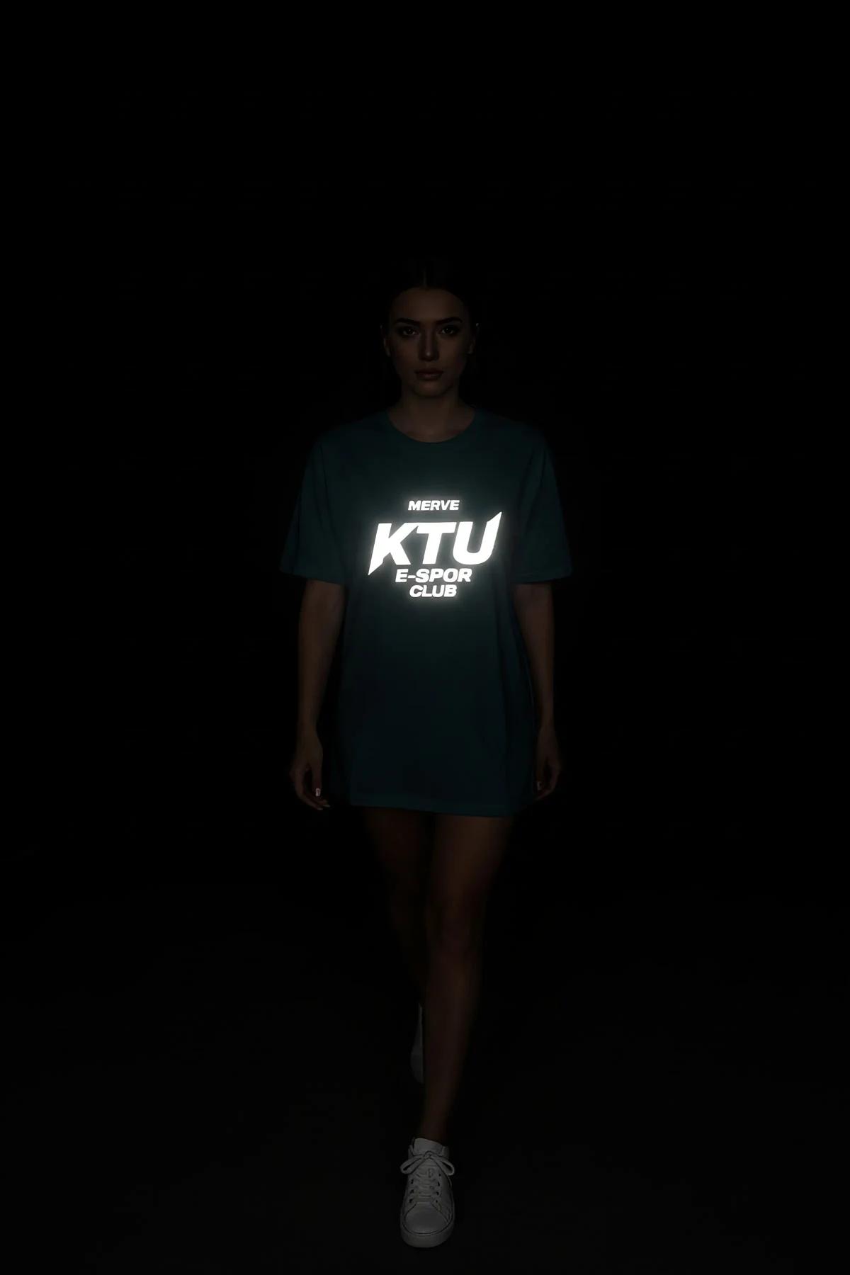black reflective t-shirt with bright white glowing logo print worn in low-light night setting