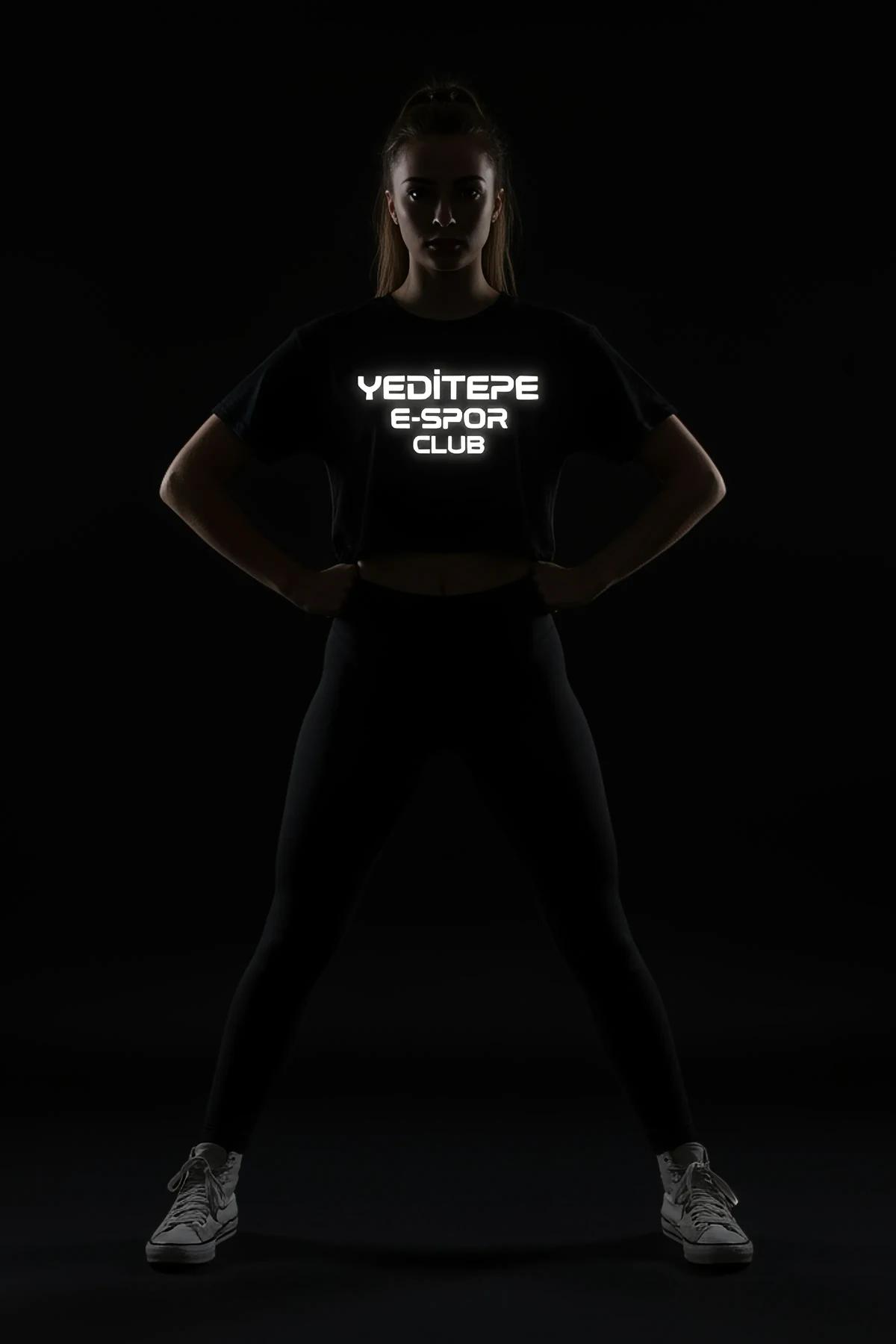 black reflective logo crop t-shirt with bold white block-letter chest graphic lit under direct light