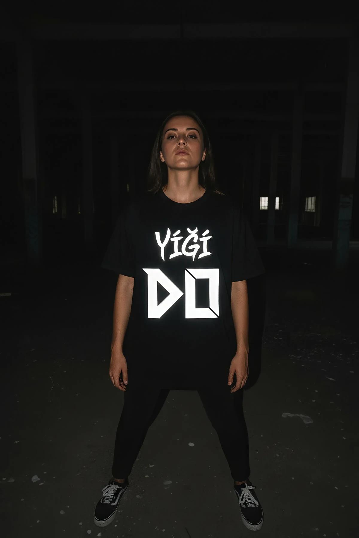 black streetwear t-shirt with large-scale reflective typography graphic front view full body