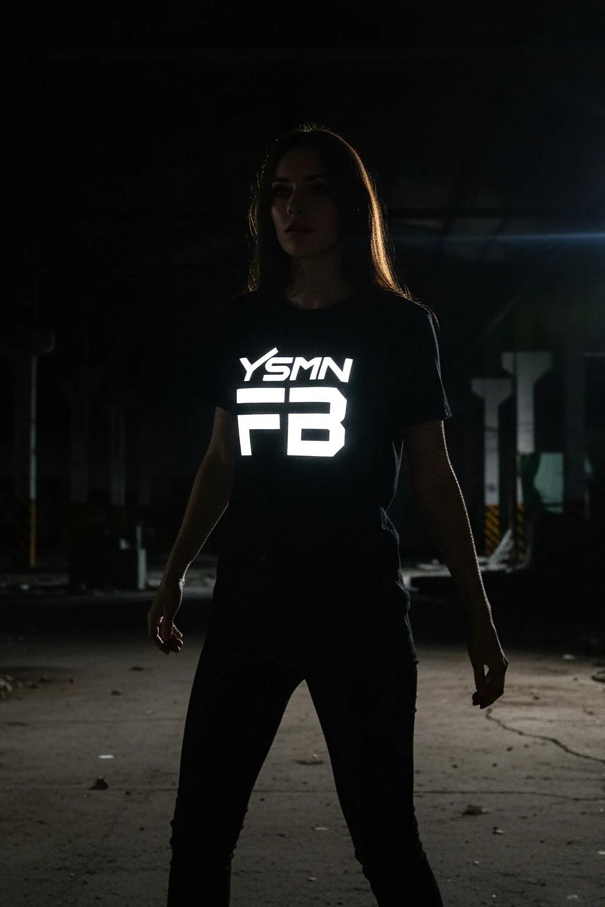 black reflective graphic t-shirt bold white YSMN logo glowing on chest in low light