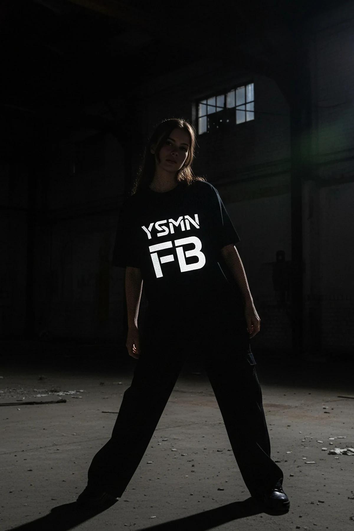 black reflective graphic t-shirt bold white YSMN logo glowing on chest in low light