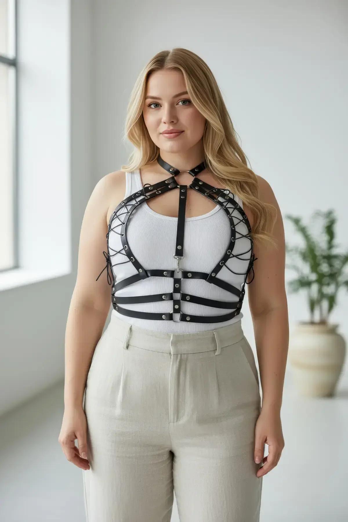 Close-up of black faux leather chest panels with white corset cross-lacing and silver stud rivets