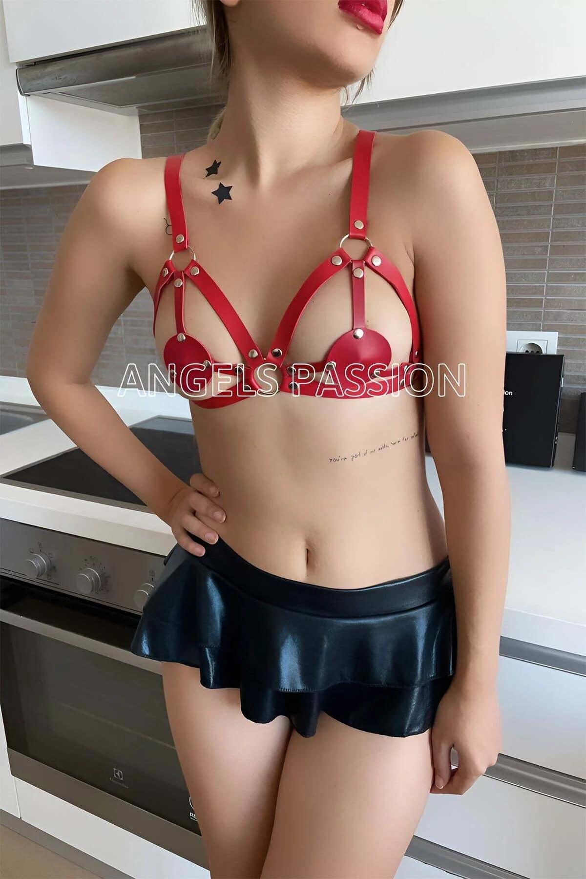 red PU leather harness bra close-up showing gold rivet studs and O-ring detail at chest