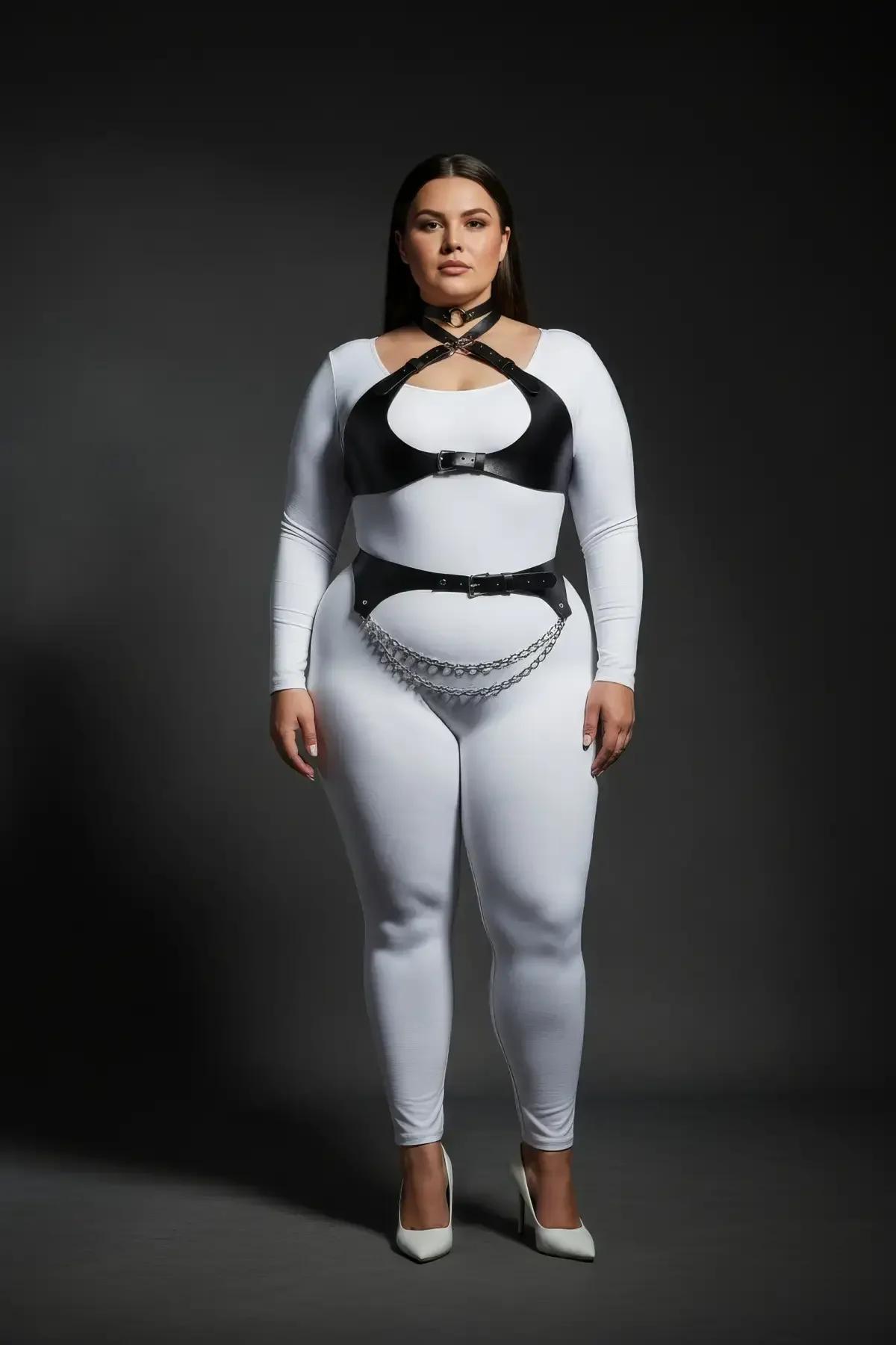 plus-size model wearing black strappy harness bra set over white bodysuit full length