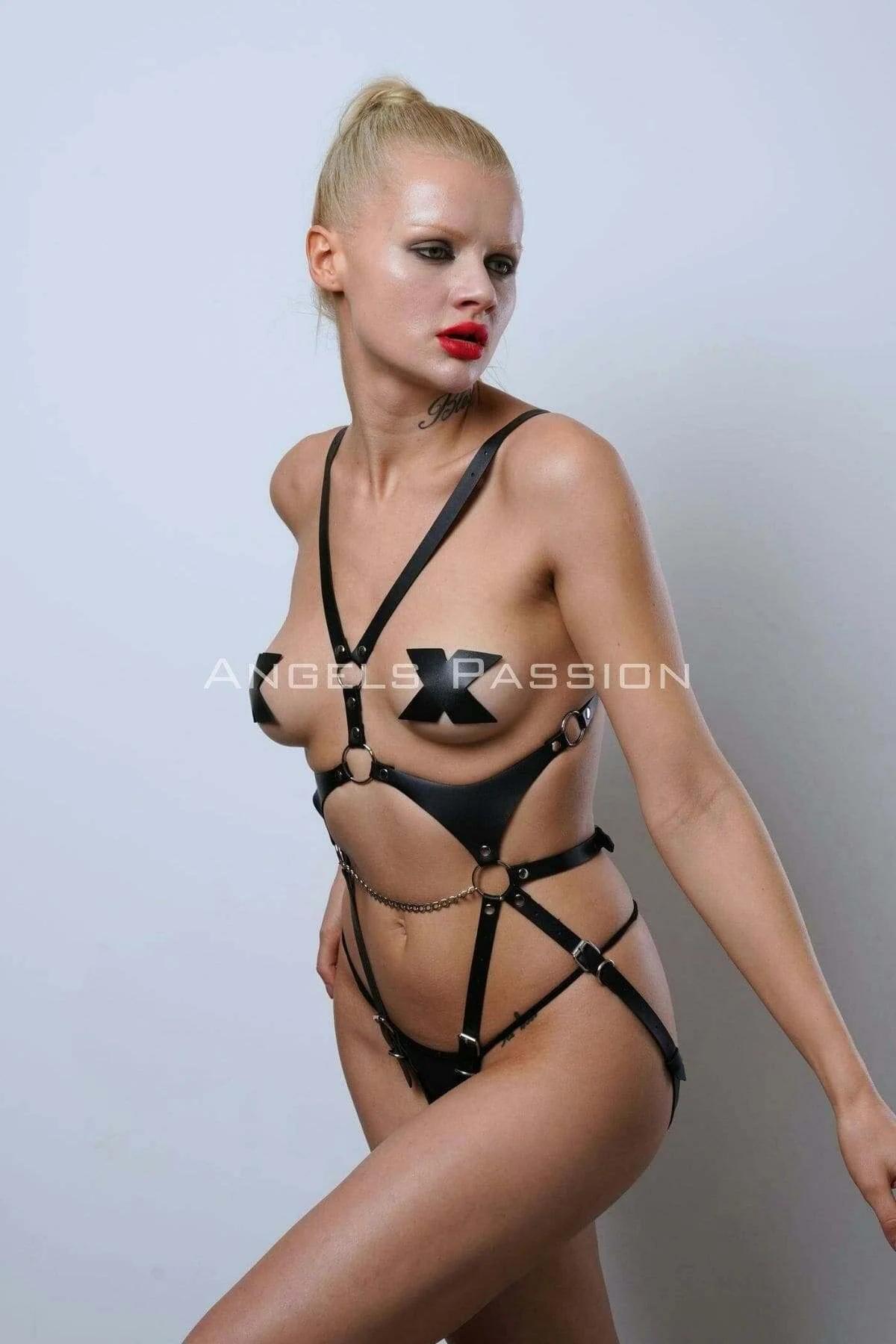 Black faux leather body harness worn over bare skin showing full chest-to-hip strap layout