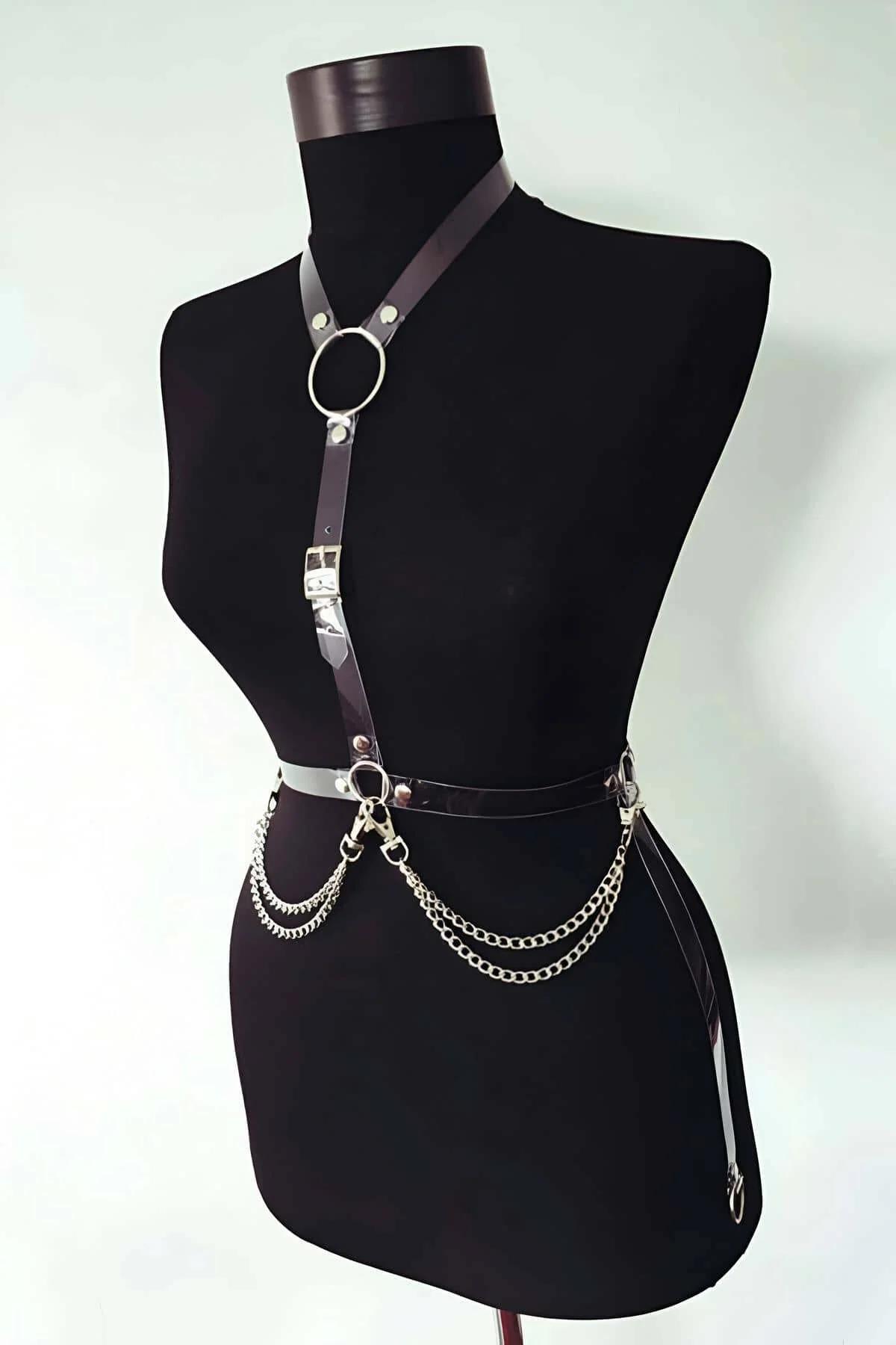 close-up black PU leather straps with silver buckle and O-ring detail on body harness