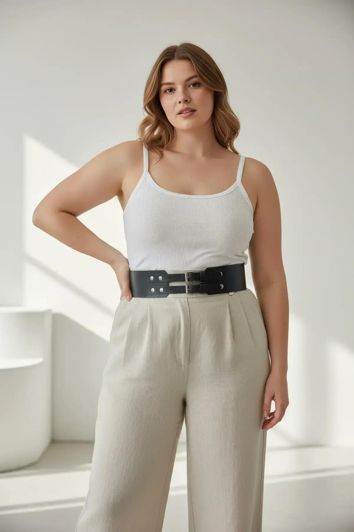 wide black faux leather waspie belt front view showing twin silver buckles and stud embellishment row