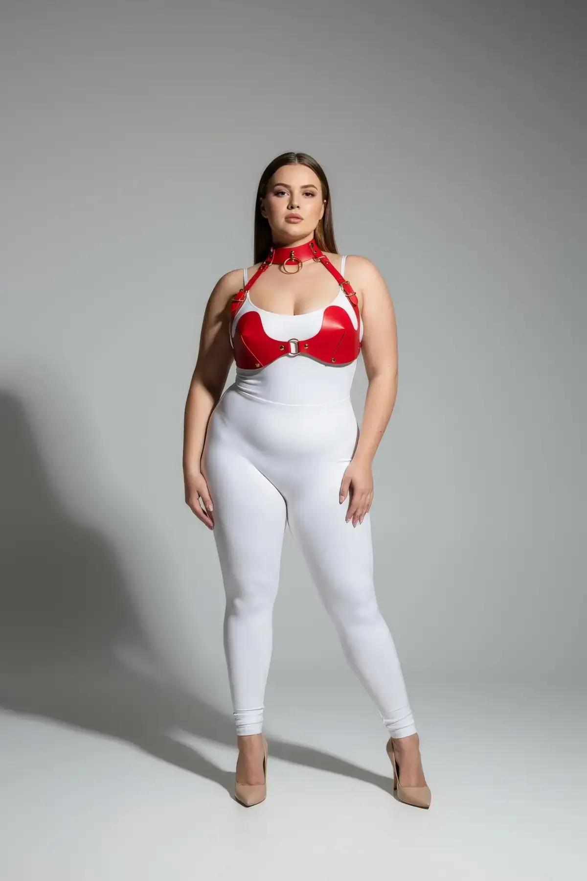 Red faux leather chest harness with molded bra cups, center O-ring, and integrated O-ring choker on plus-size model