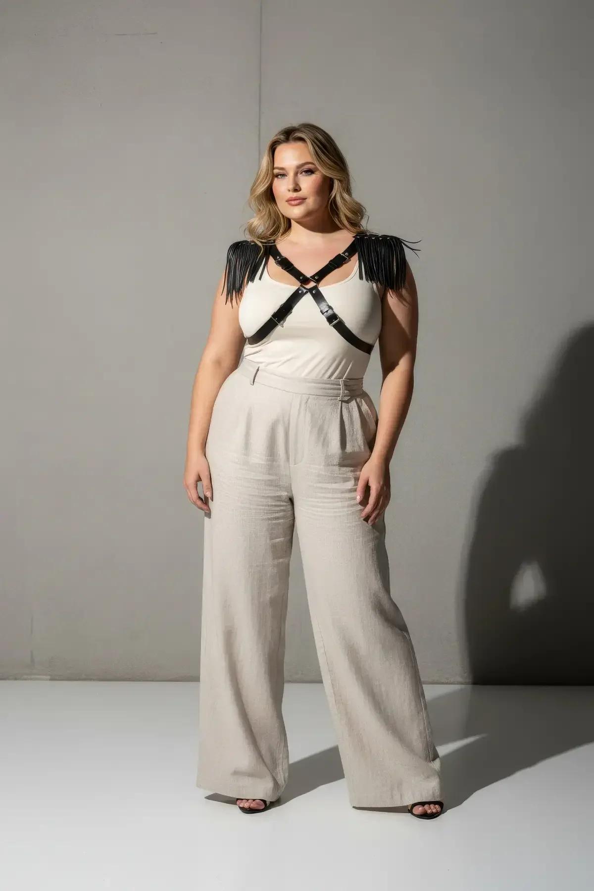 black fringed chest harness laid flat showing full X-cross strap layout and fringe strip length