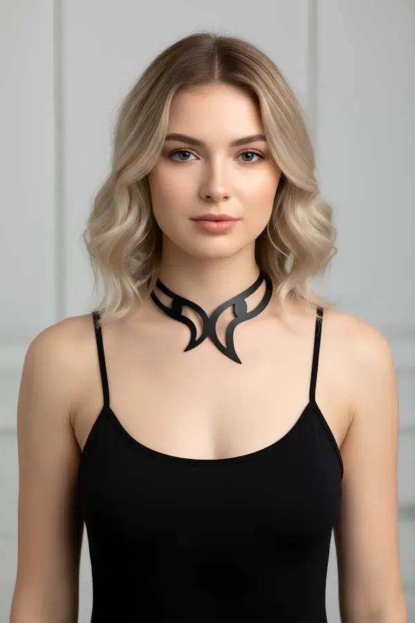 Black matte faux leather sculpted choker with tribal flame cutout silhouette worn against the collarbone