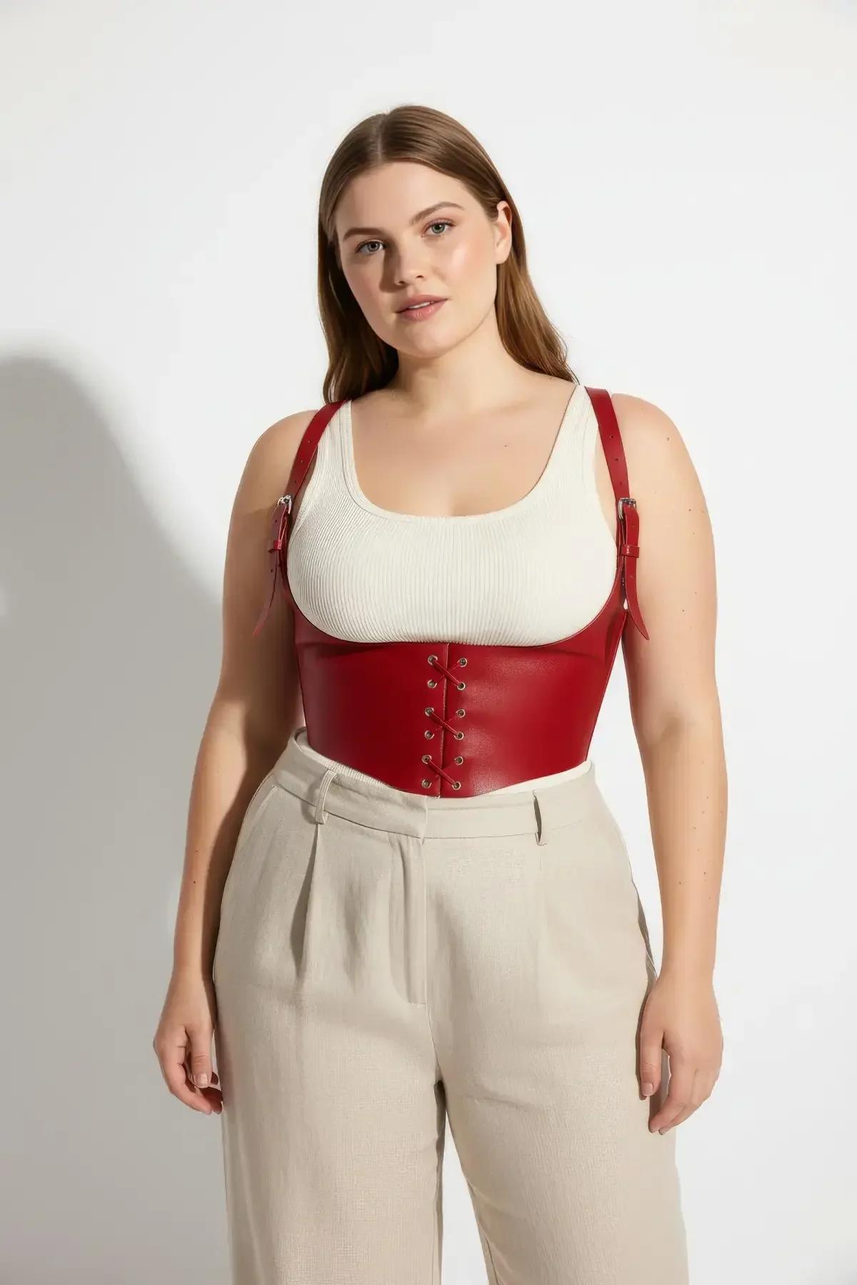 back view of red faux leather underbust harness showing adjustable strap buckles and panel structure