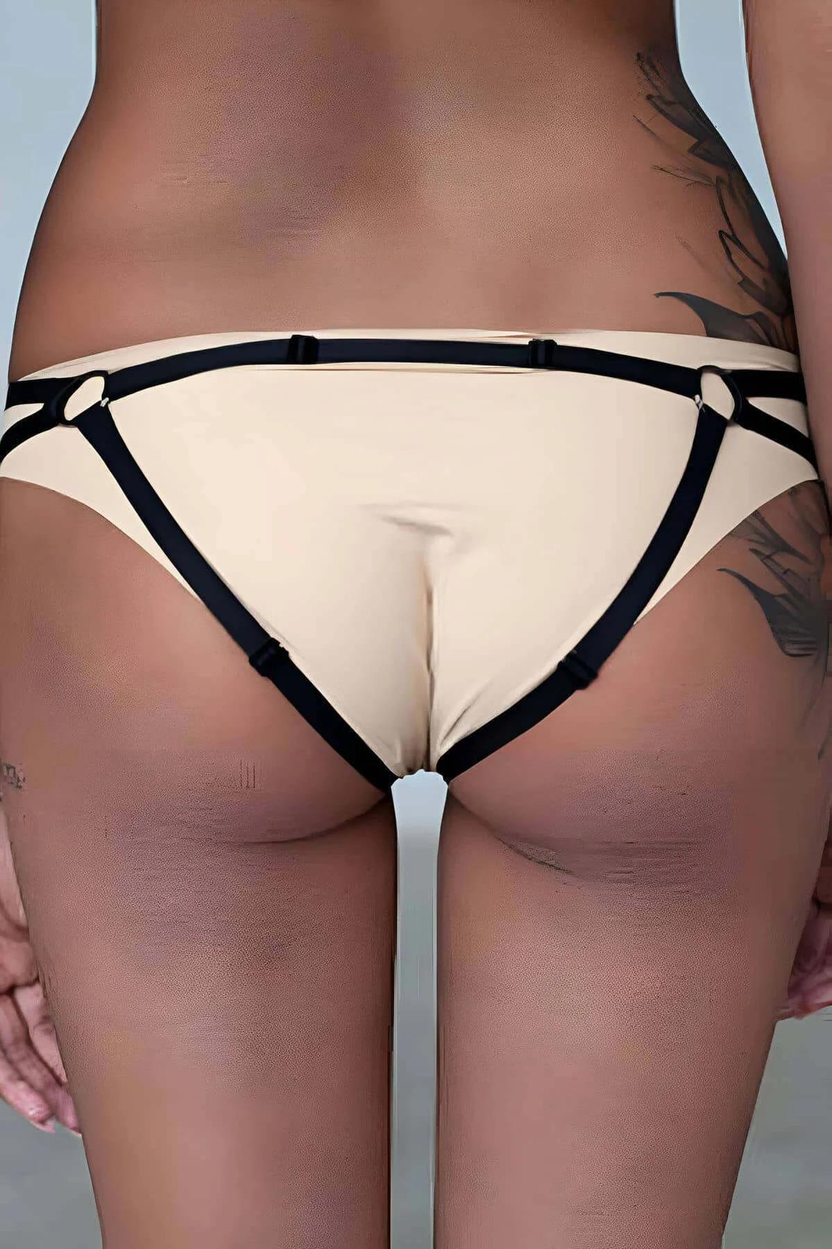 cream crop top with black halter harness straps and gold O-ring front center detail
