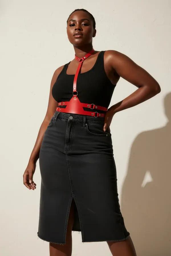 Red faux leather chest harness with silver O-rings and integrated choker collar worn over black bodysuit