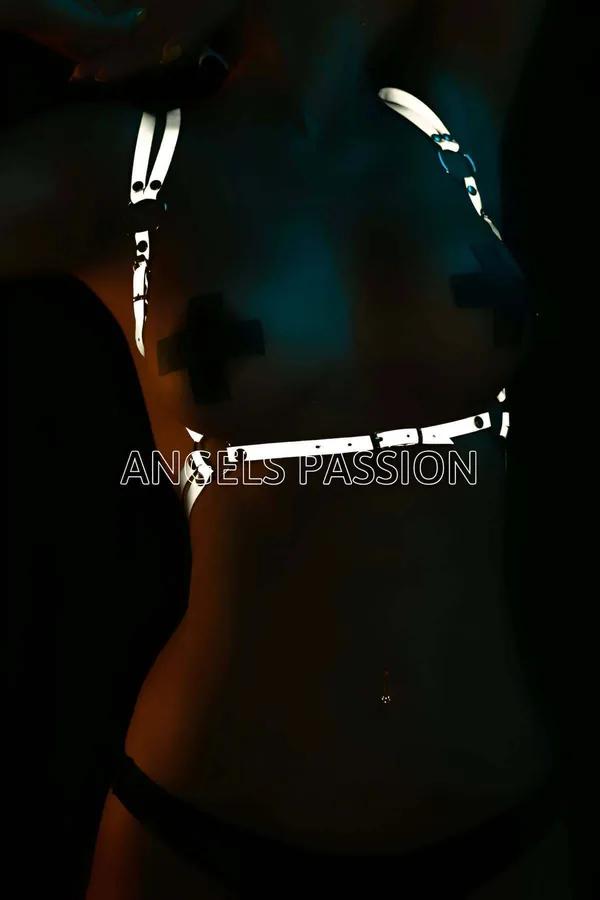 Reflective body harness top white glowing straps on dark background club lighting festival accessory adjustable