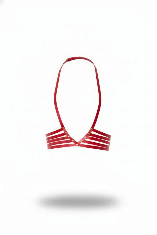 Red faux leather caged harness bralette with four horizontal straps and gold stud V-center, halter neck buckle