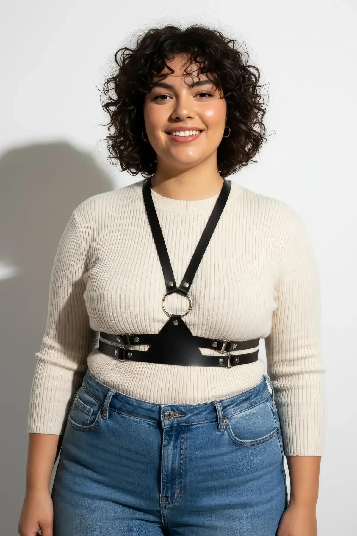 black vegan leather belt harness worn over denim jumpsuit showing full-length Y-strap silhouette