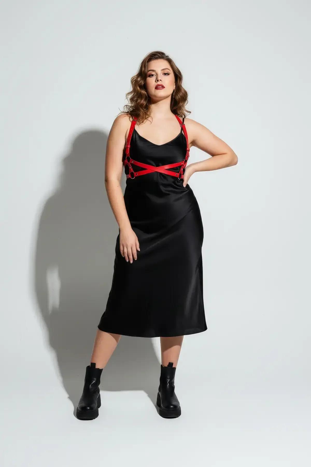 plus size red faux leather chest harness layered over black midi dress full length view