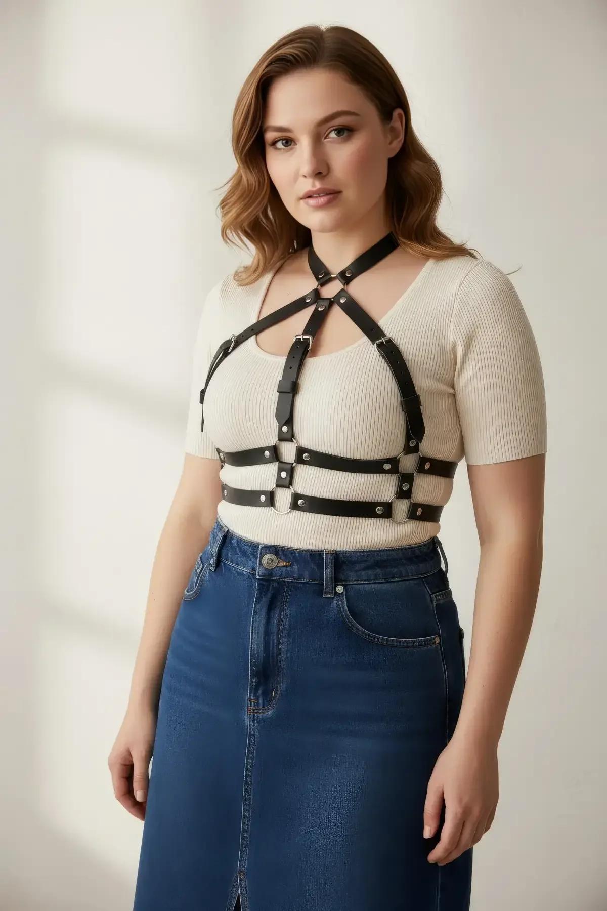 adjustable cage harness in black PU faux leather with central snap-buckle sternum closure detail