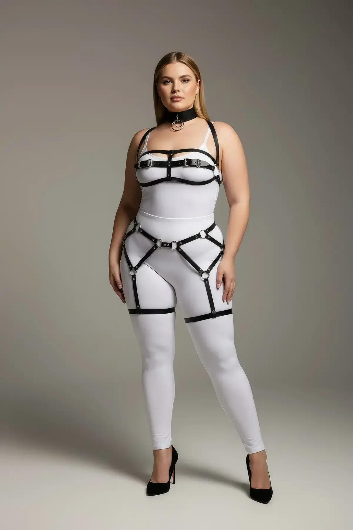 Close-up of silver O-ring and buckle hardware on black faux leather chest harness straps