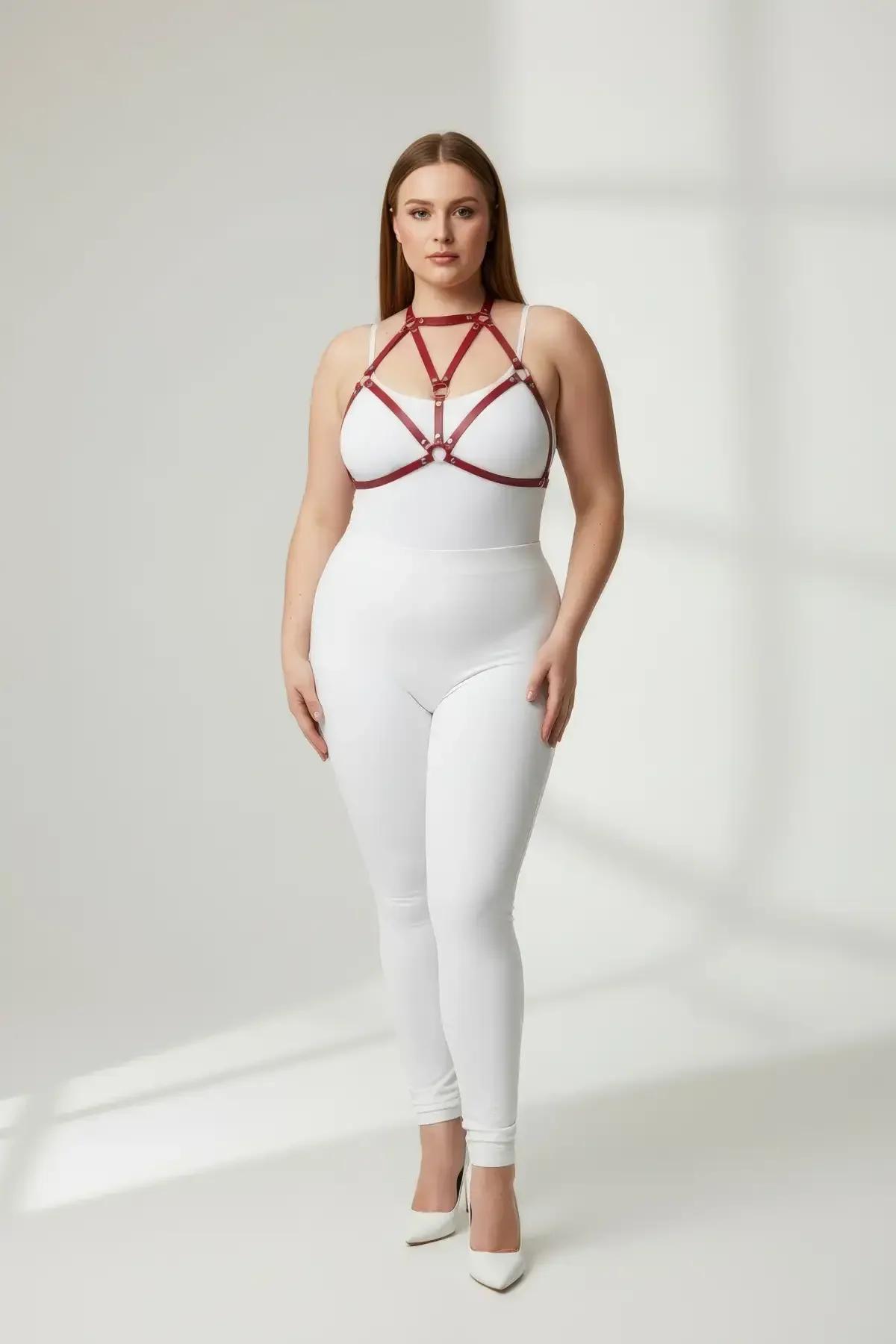 red strappy chest harness with six gold O-ring hardware details close-up front view