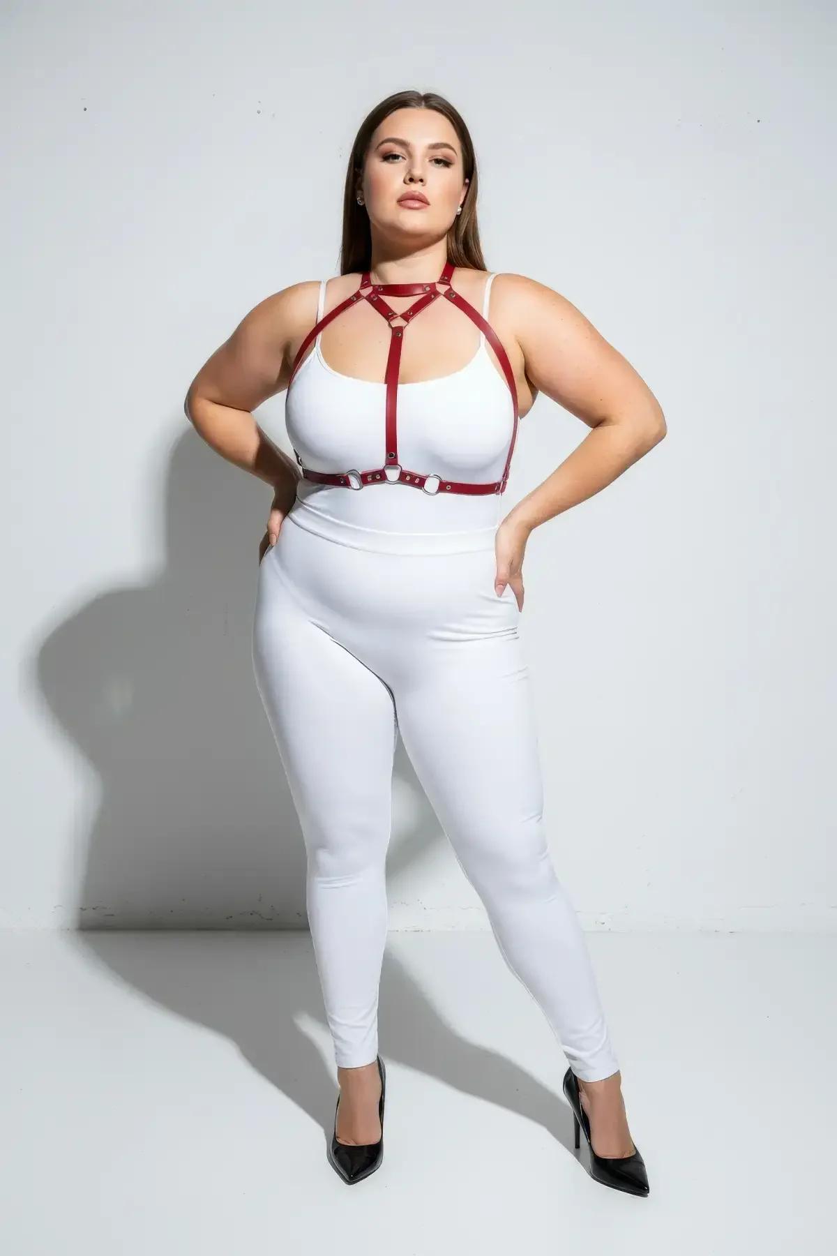 close-up of silver zinc-alloy O-ring detail on red faux leather body harness