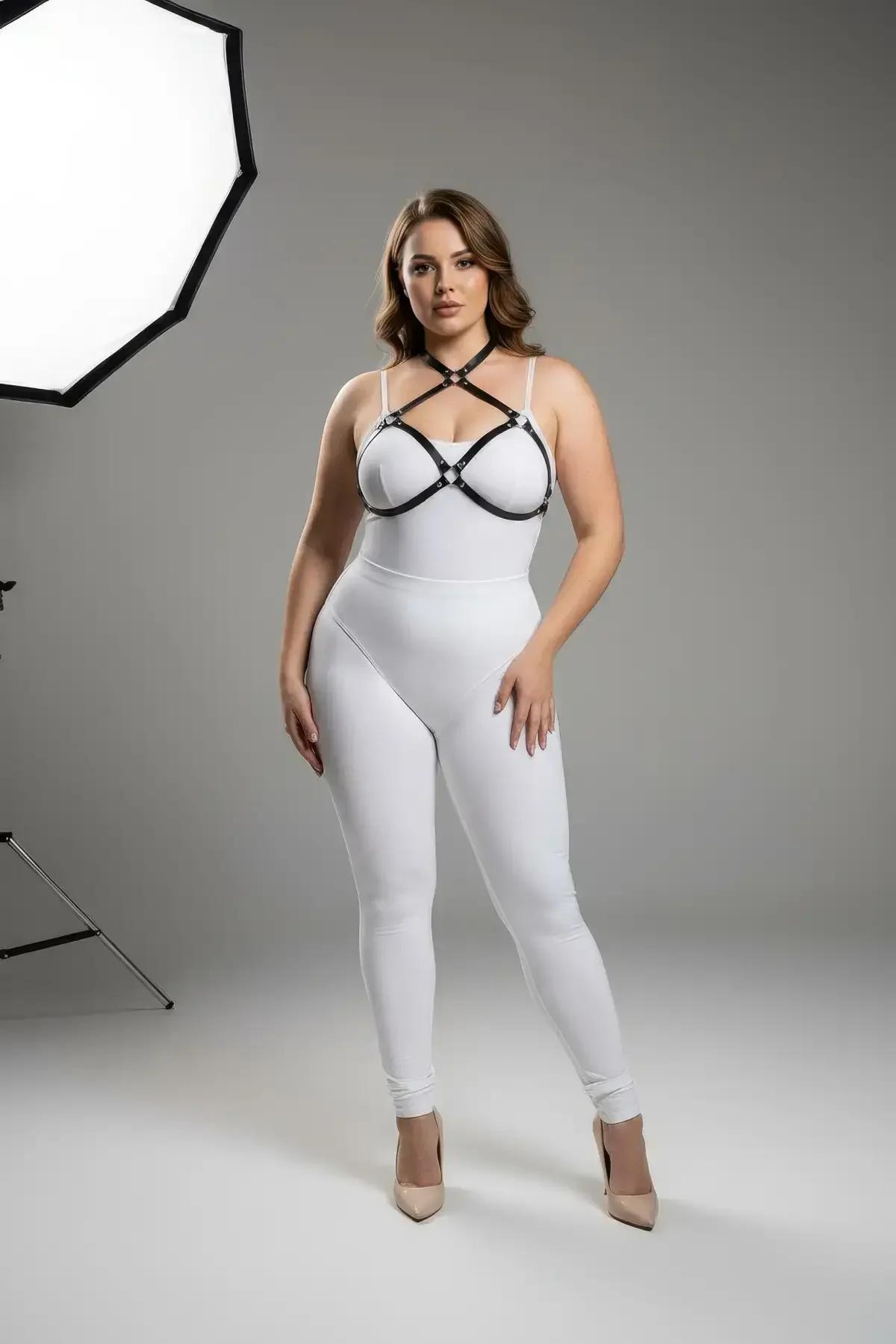 Black vegan leather chest harness criss-cross strap detail with multiple silver O-ring connectors