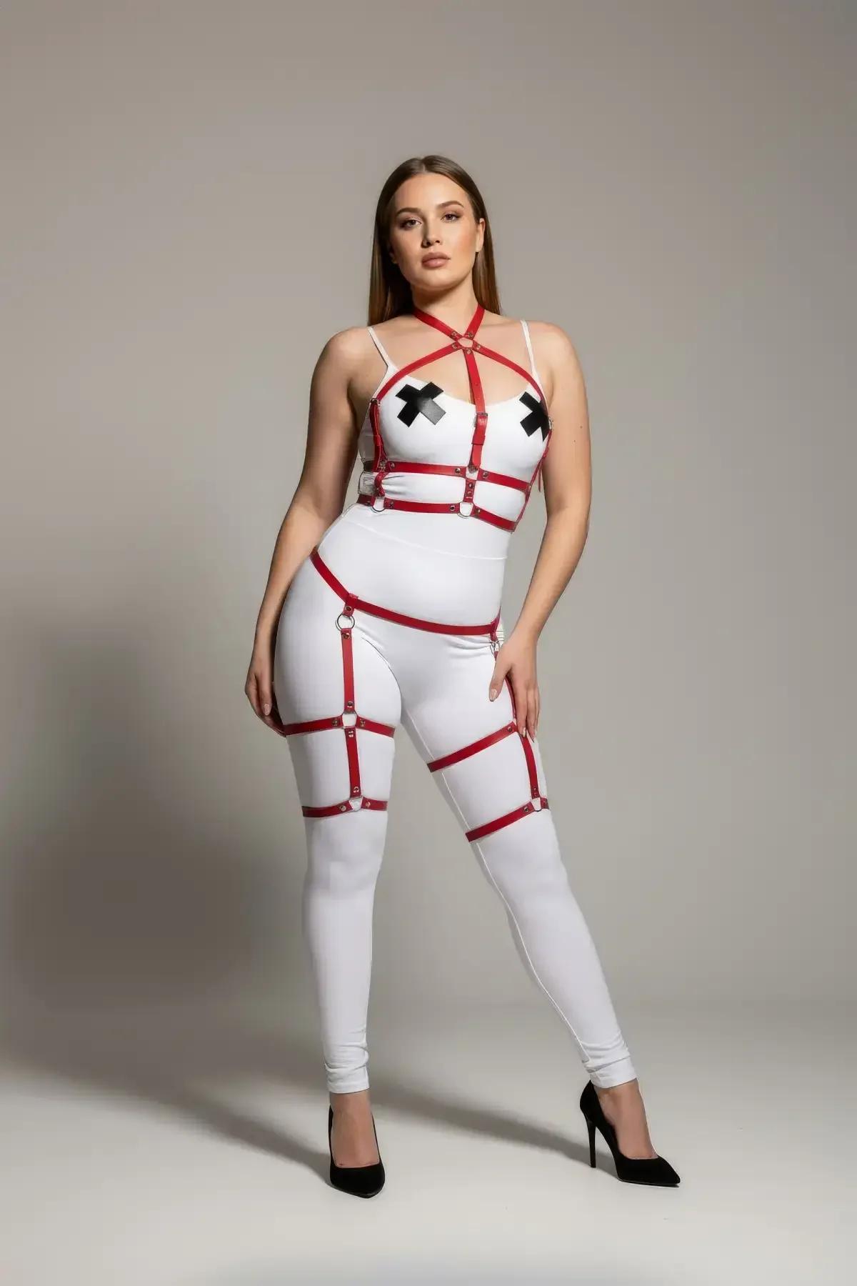 Close-up of red faux leather criss-cross chest harness with silver O-ring center detail and halter-neck strap