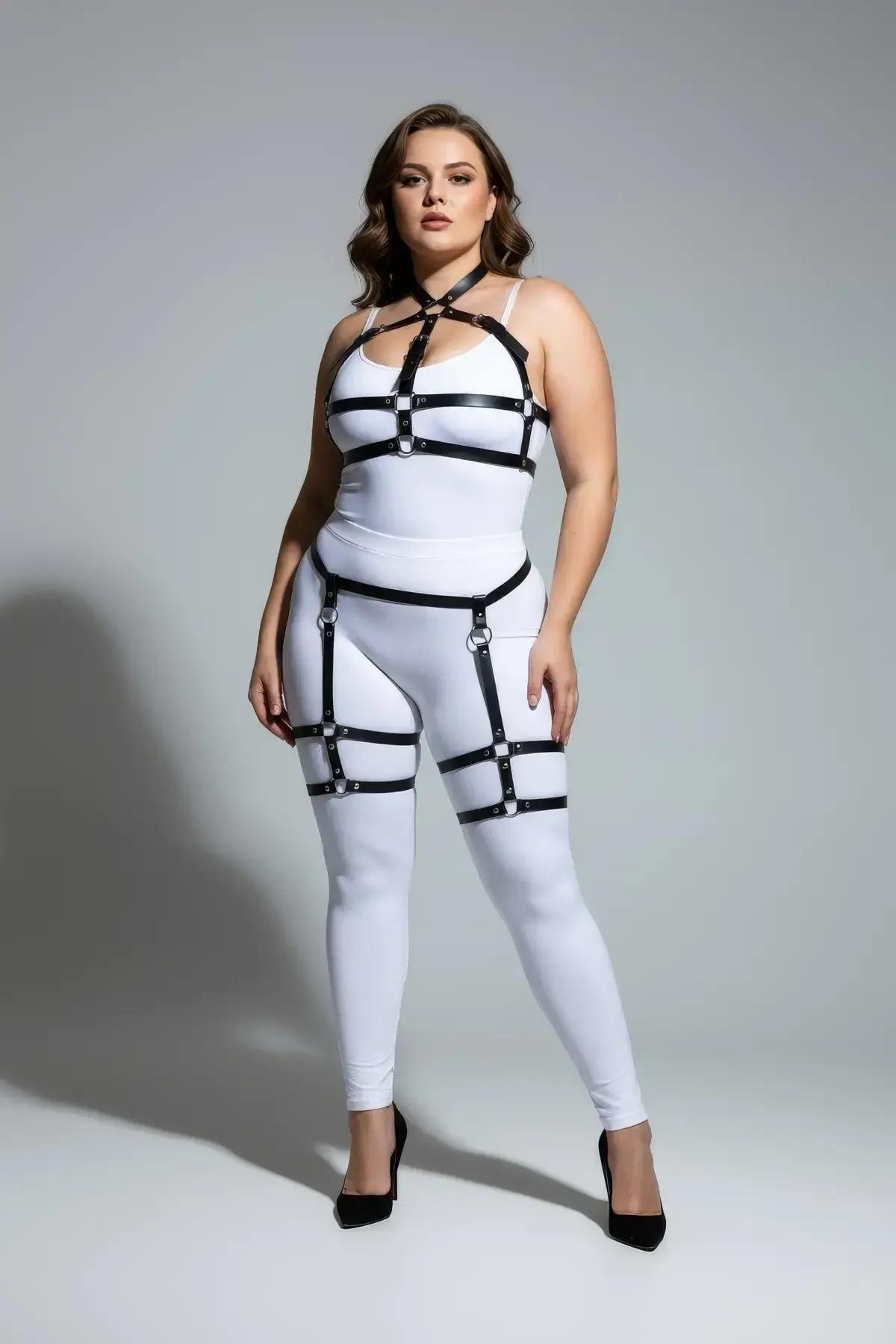 Close-up of silver O-ring chest connector on black faux leather full body harness
