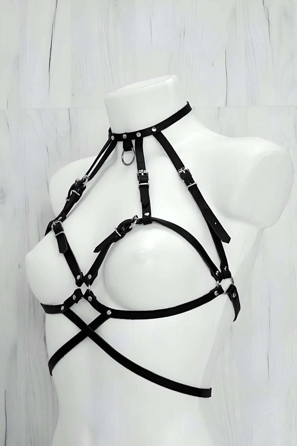 Black PU leather chest harness with silver O-ring center detail and adjustable slider buckle closeup
