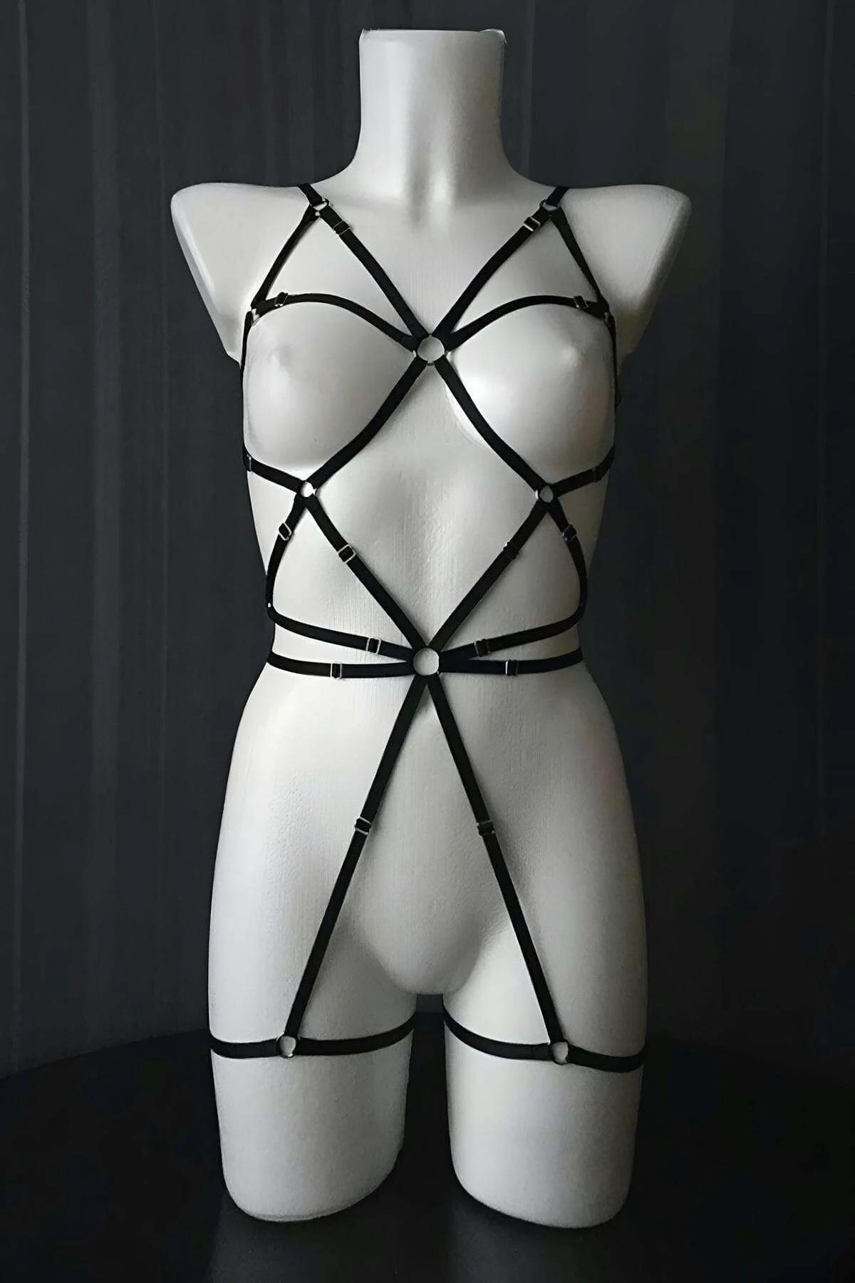 Close-up silver O-ring center waist and 1 cm black faux leather strap detail on polka dot mesh bodysuit