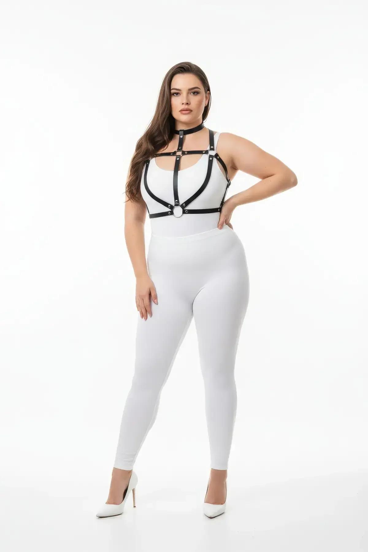 Black faux leather strappy chest harness with silver O-ring detail and integrated choker worn over white outfit