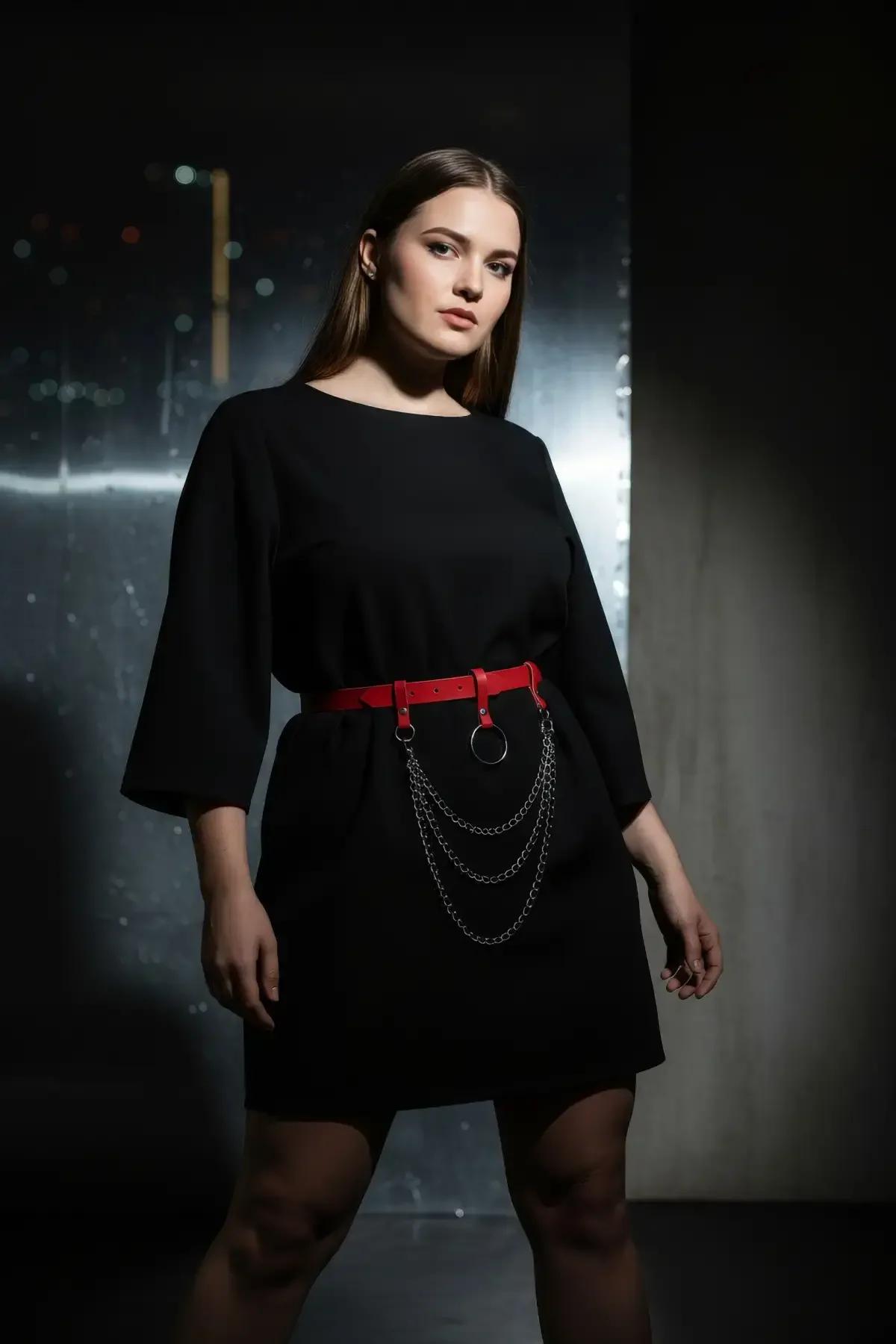 close-up of red PU leather strap and black O-ring hardware with layered silver chain drape