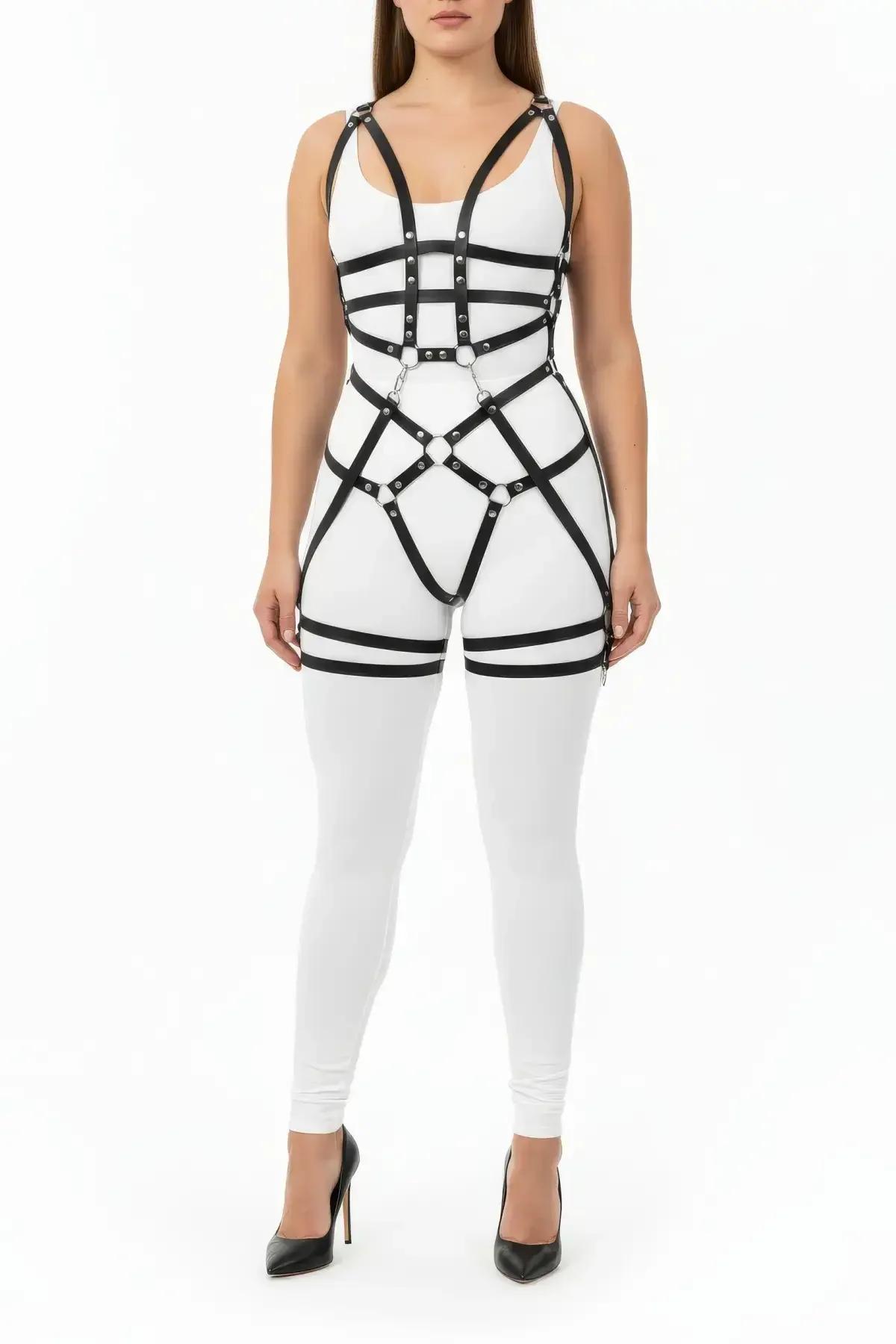 close-up of silver O-ring cluster at waist intersection on black faux leather full body harness with stud hardware