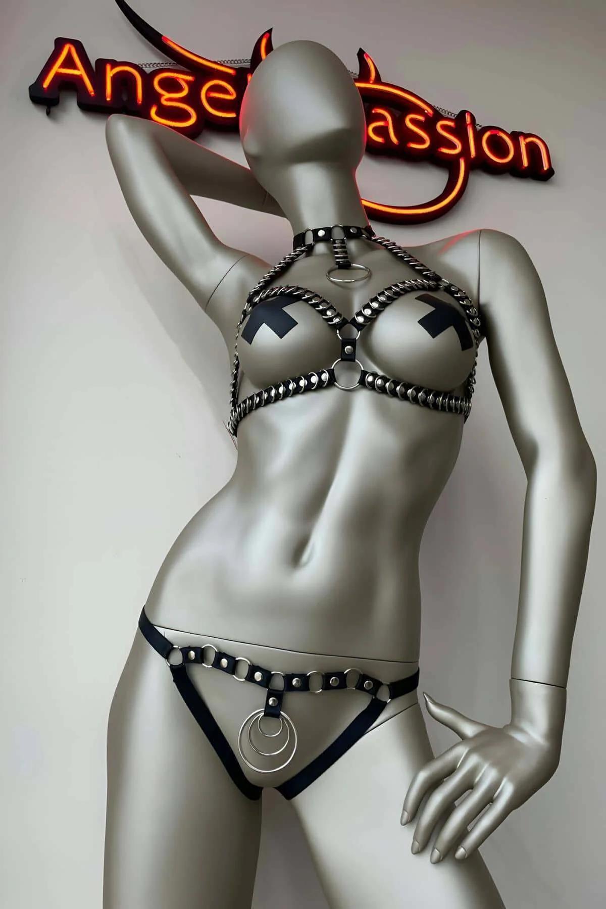 Back view of black faux leather bra harness showing metal buckle closure and adjustable strap hardware