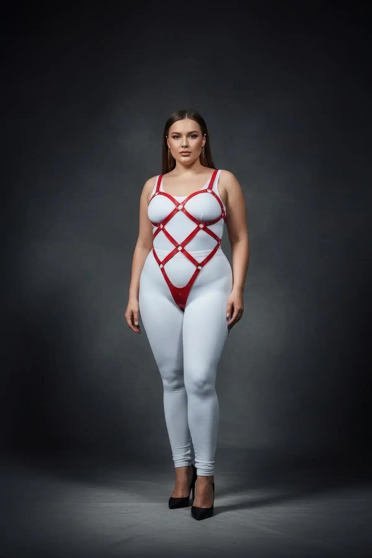 plus-size model wearing red full body harness with geometric strap lattice and thong base