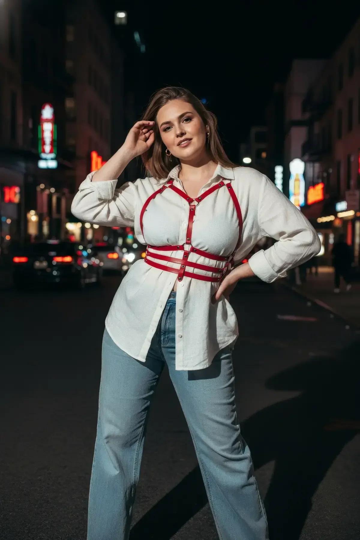red strappy body harness worn over cream trousers showing full torso cage structure