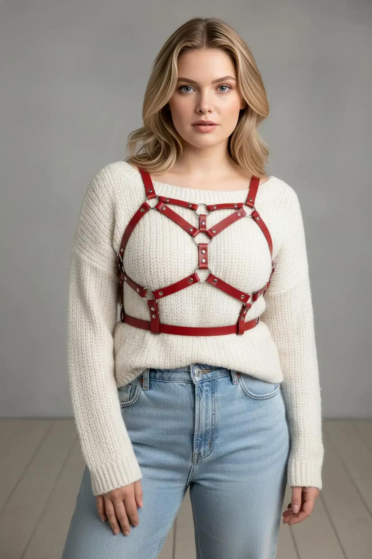 Red vegan leather harness bra with silver stud rivets and horizontal waist band, product flat lay