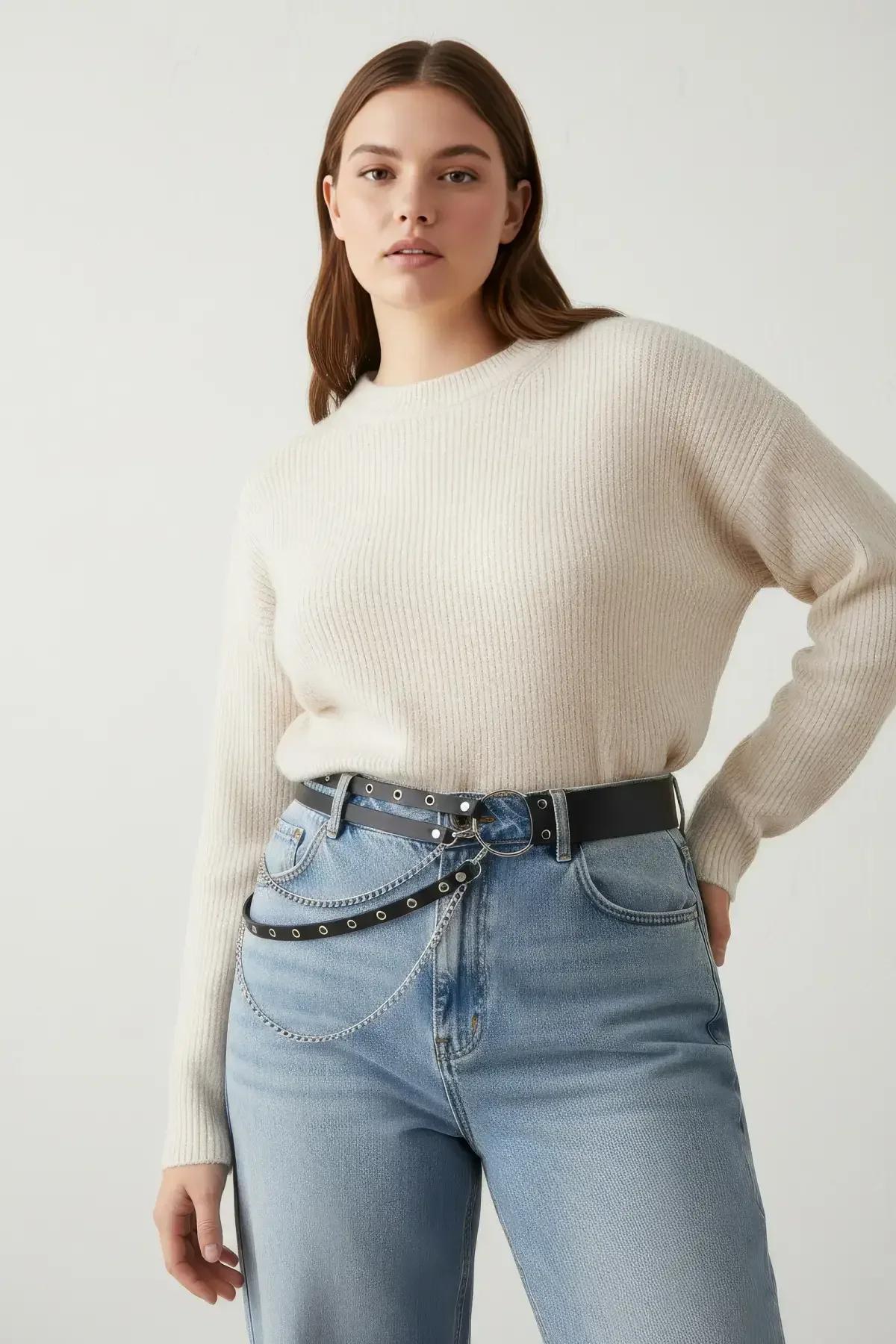 black double-row belt with chain drapes styled over jeans on plus-size model