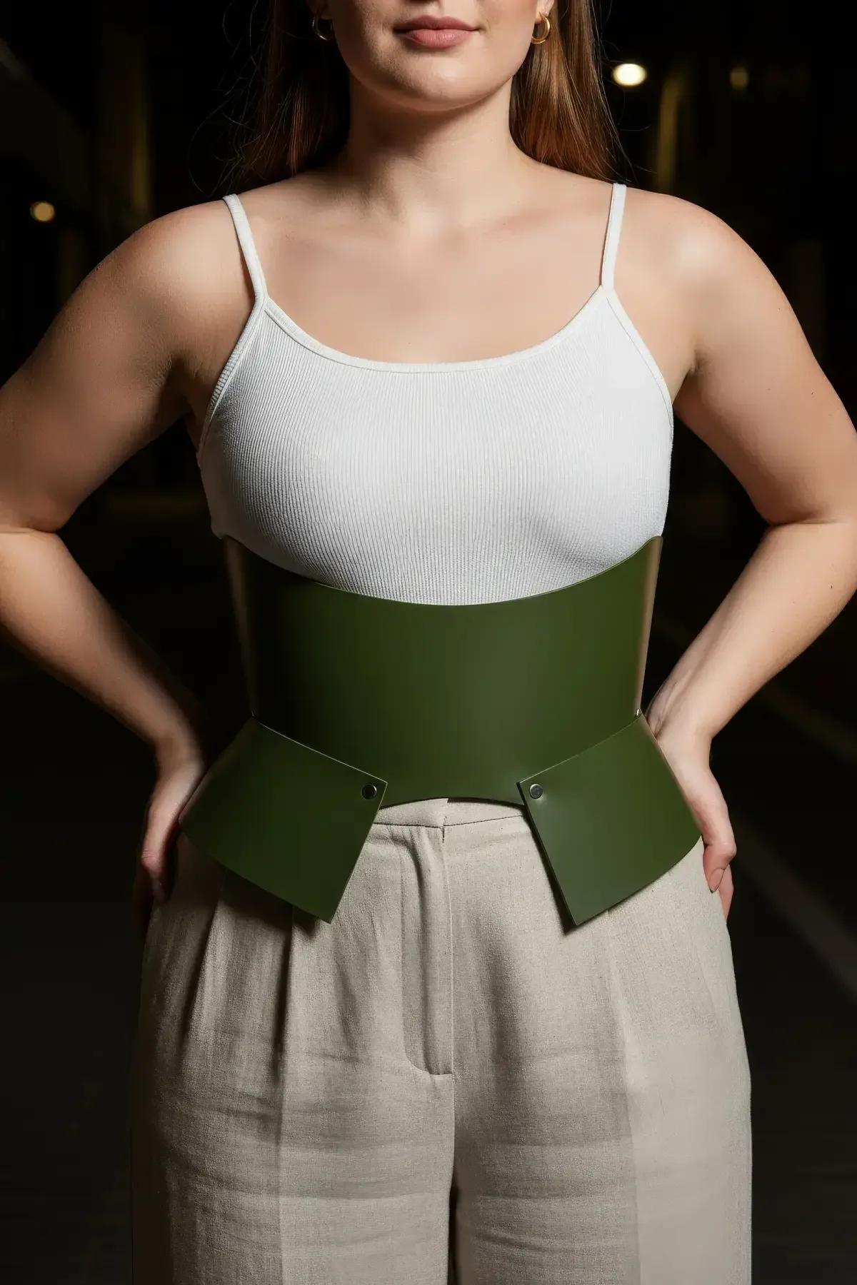 olive green wide corset belt styled over beige trousers street fashion waist accessory