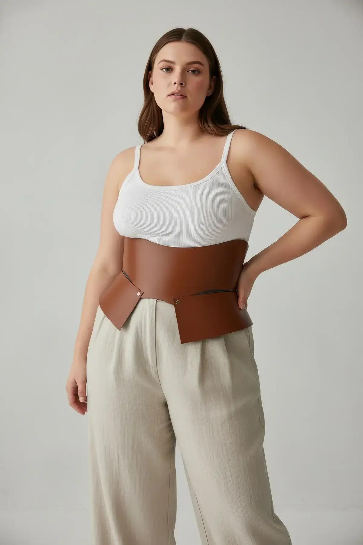 structured tan PU waspie belt front panel detail showing gold-tone zinc alloy stud hardware