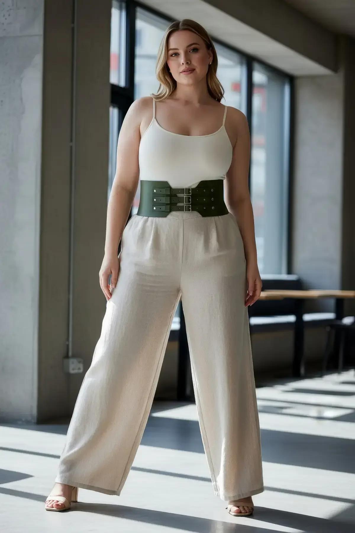 olive green structured waist harness belt worn over pleated midi skirt daytime styling
