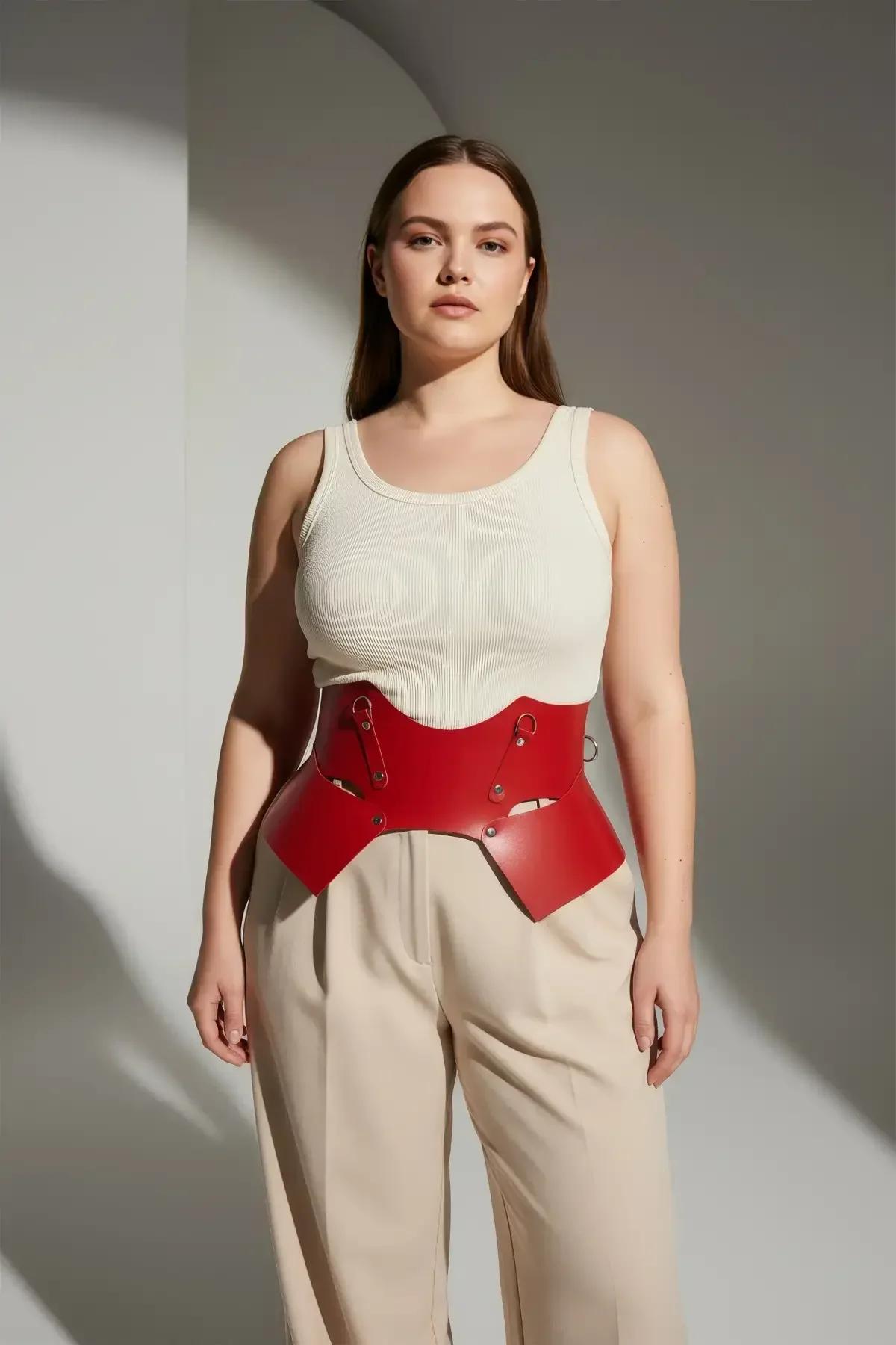 flat lay of red sculpted waist harness belt showing full panel shape and silver hardware